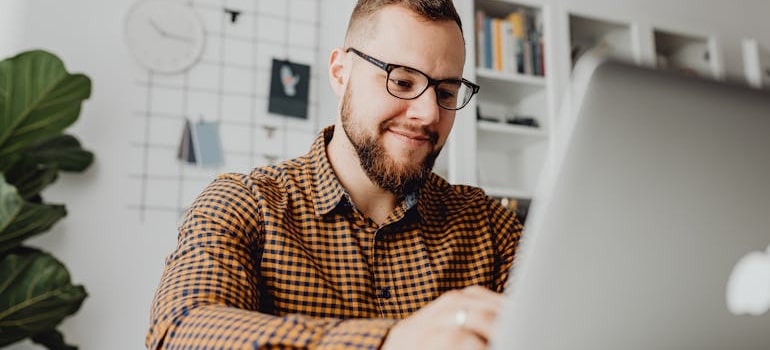A satisfied person using a laptop