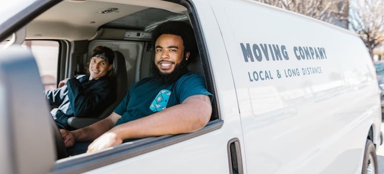 Two movers in a moving van