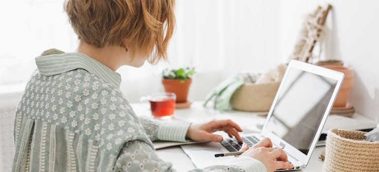 A person using a laptop to read about why organic traffic matters for moving companies