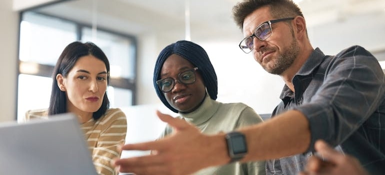A team experts discussing how digital marketing can help moving companies offset rising operational costs