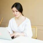 A person using a laptop to learn about tactics to rank for estimate related searches