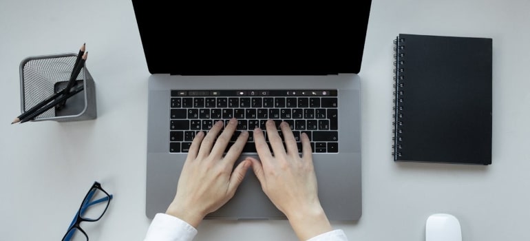 a woman typing on her laptop 