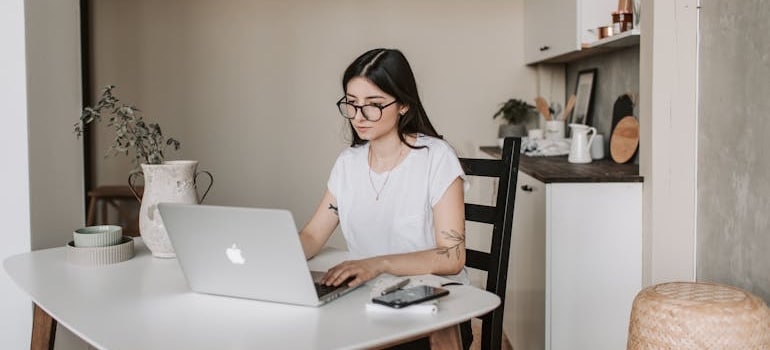 A person searching online, looking for top 2025 digital marketing trends for moving companies
