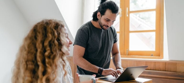 A person using a laptop to look for moving companies