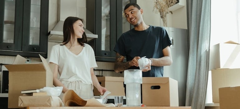 Two people packing their items and preparing for a move