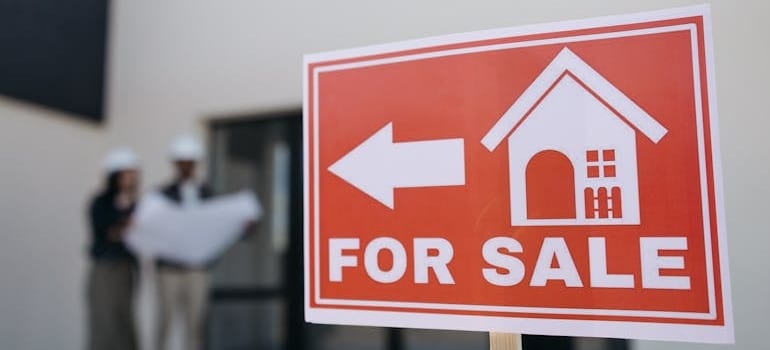 A red house for sale sign