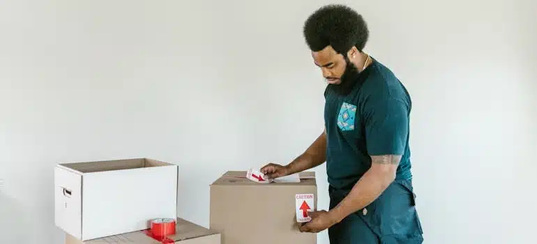 A moving company employee packing boxes