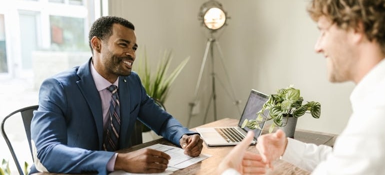 A professional has insurance and liability explained for movers and clients to a person