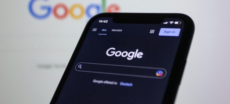 Google search interface on a smartphone screen, highlighting SEO visibility as part of the pros and cons of redesigning your website.