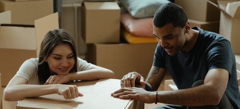 A couple packing boxes