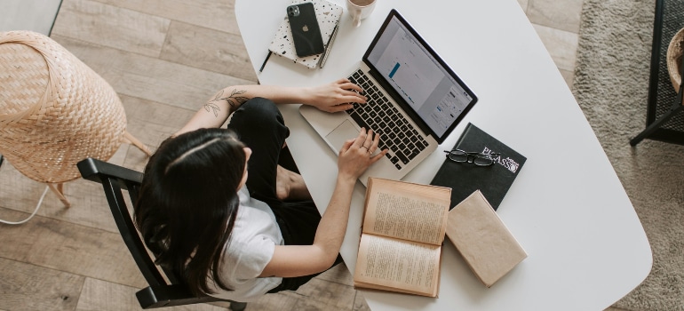 Young professional analyzing SEO data on a laptop, using online strategies to grow your moving company.