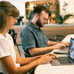People using laptops to explore landing page trust signals that increase booking rates and customer confidence.
