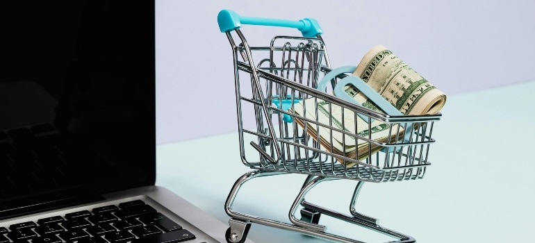 Laptop with cart figure displaying secure checkout