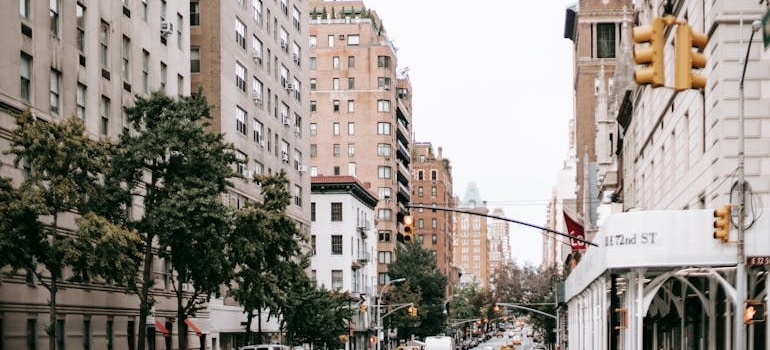 A busy city street lined with apartment buildings