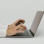 A person using a laptop to look for moving services