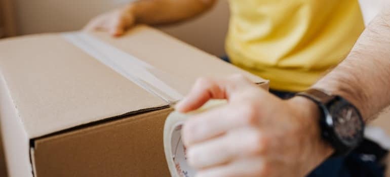 A person showing how to pack, which is an example of educational social media ad campaigns every moving company should try