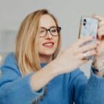 A person using a smartphone to explore services of a moving company