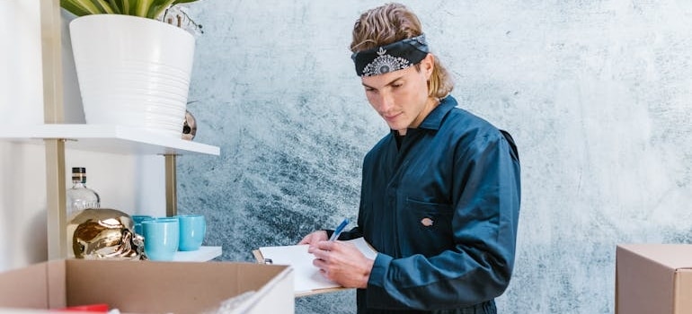 An employee of a moving company making a list of items before packing