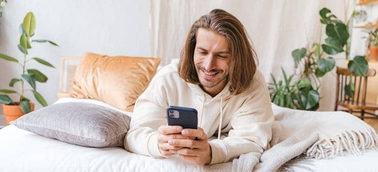 A person using their smartphone to look for moving companies
