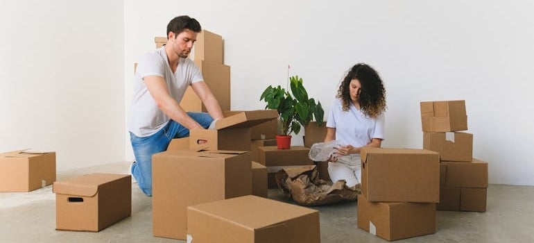 Two people preparing for a move with a company that knows how to offer friends and family discounts without losing profit