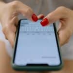 An upside-down close-up of a person receiving an SMS.
