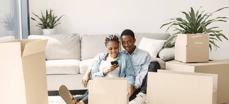 A couple contacting a moving company that has compared live chat vs phone calls and uses both