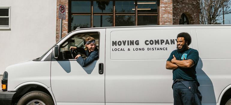 Moving company team next to a branded moving truck