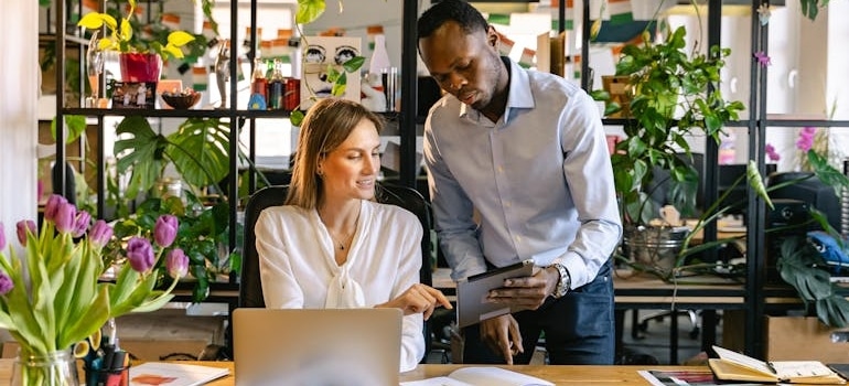 Two colleagues discussing competitor analysis tools