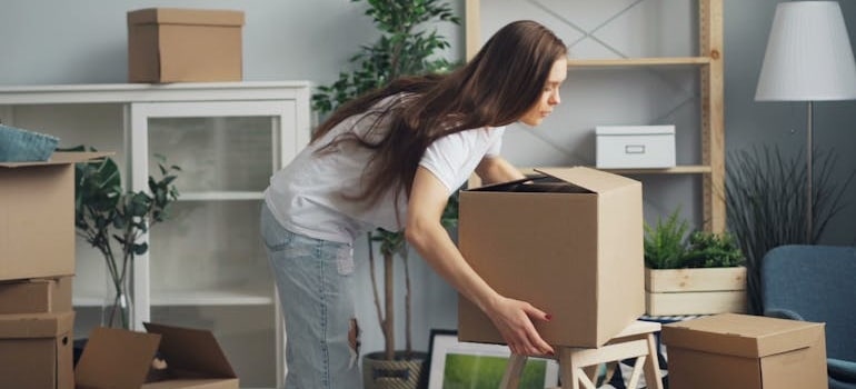 A person preparing boxes for their move