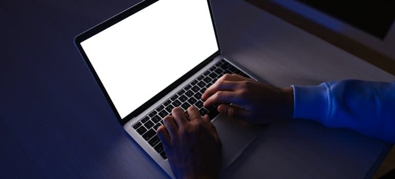A person typing on a laptop