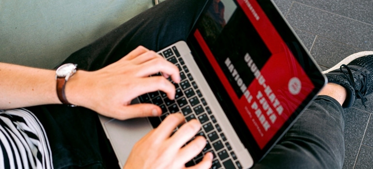 A close-up of a person visiting a movers website.