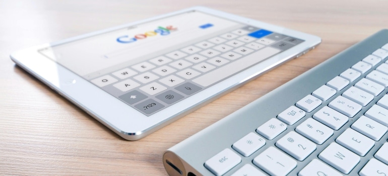 A close-up of a tablet with Google homepage.