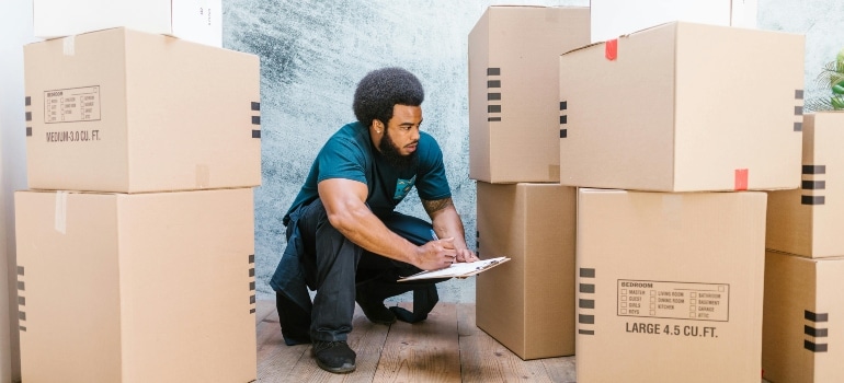 A movers employee looking at boxes.