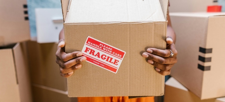 A close-up of a person holding a package.