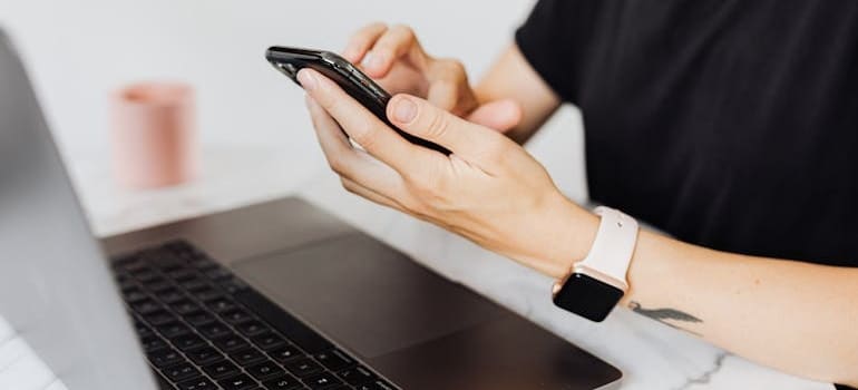A person using a smartphone to book services from a moving company after they applied booking form tweaks