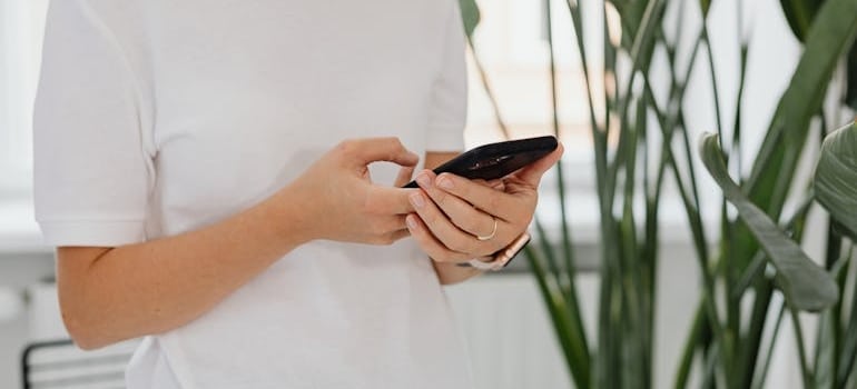 A person using a smartphone reading an email from a company that knows how to automate follow-up emails
