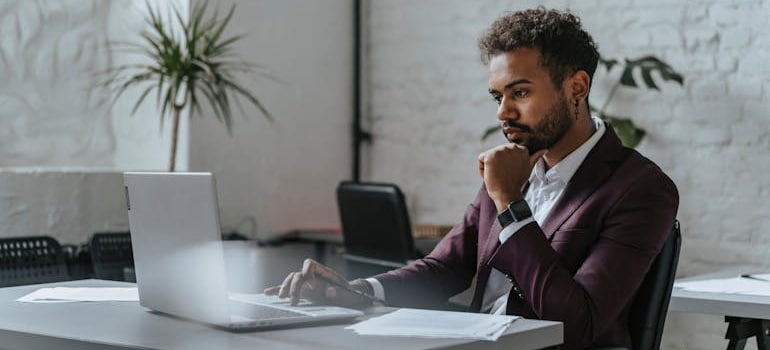A company owner doing online research on how AI helps movers spend marketing budget