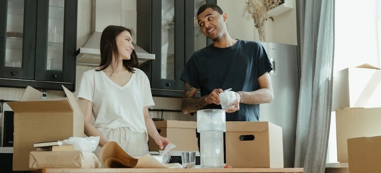 Two people packing their items before a relocation