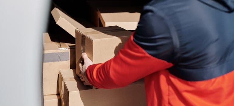 A moving company employee loading boxes