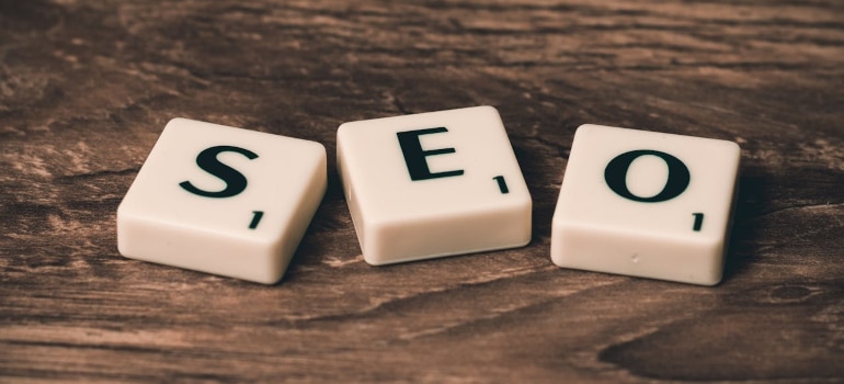 SEO strategy concept represented by tiles spelling SEO on a wooden surface