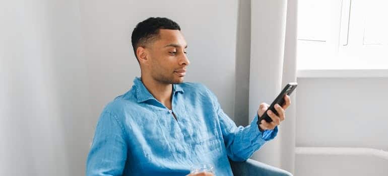 A person using a smartphone to look for moving companies