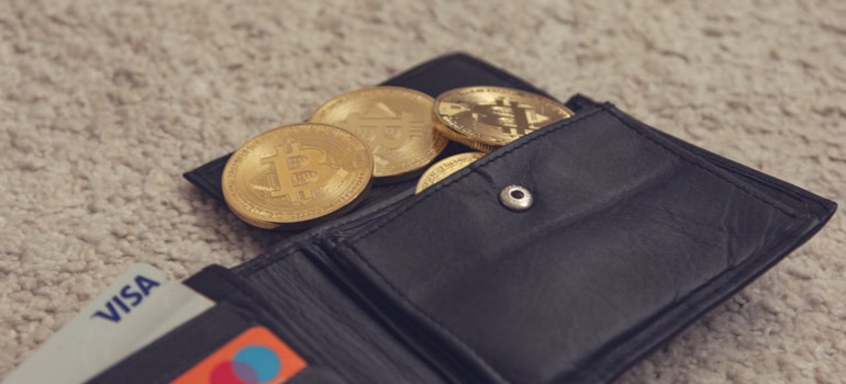 Wallet showing Bitcoin coins and credit cards as diverse payment methods