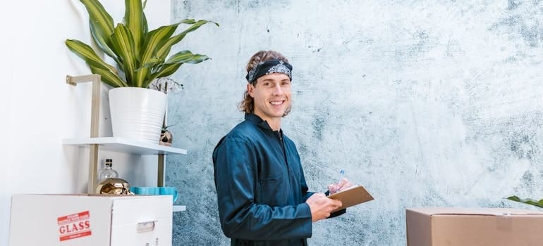 An employee of a moving company preparing boxes for a relocation