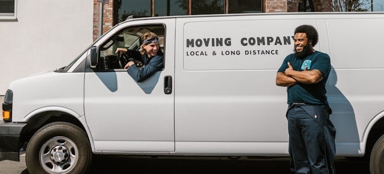 Two employees of a moving company and their van