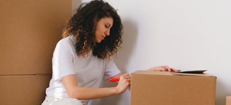 A person preparing boxes for a relocation