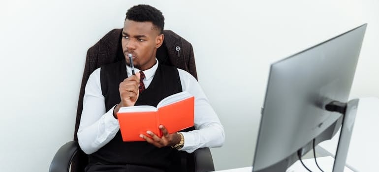 A manager thinking about different names after doing research about naming your moving business