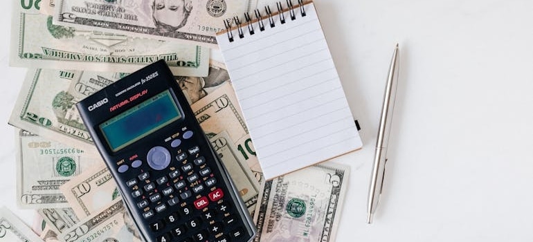A calculator and a notepad used for caclulating budget