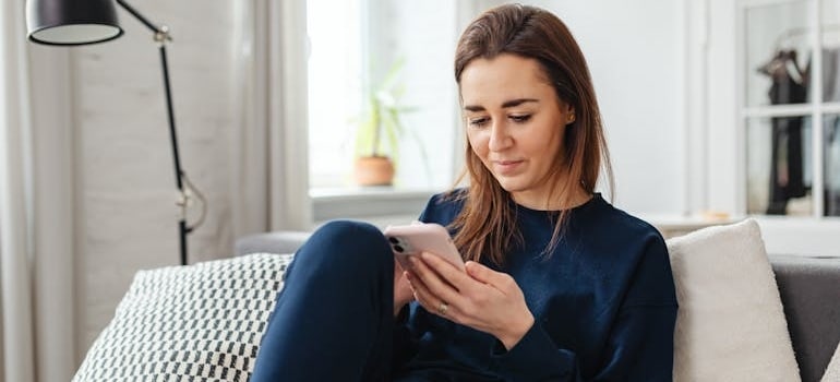 A person using a smartphone to look for moving companies