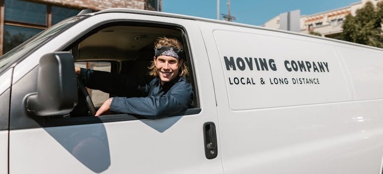 An employee of a moving company in a van