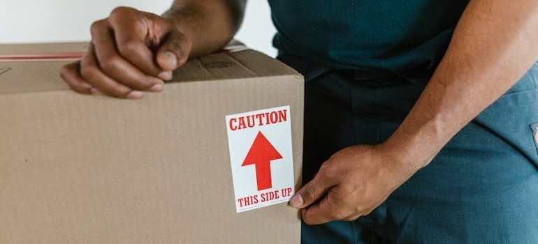 An employee of a moving company packing boxes